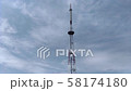 Telecommunication tower blue clouds on blue sky  58174180