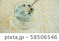 Pouring hot water into a glass cup with dried flowers of blue tea 58506546