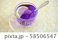 Adding a slice of lemon to the glass cup of freshly prepared blue tea 58506547