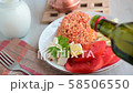 Adding olive oil into Turkish dinner with bulgur pilaf, feta cheese, fresh tomato and cucumber 58506550