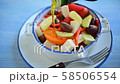 Slow motion of pouring olive oil onto Greek salad with feta cheese, Kalamata olives, cucumber, tomato 58506554