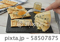 Woman makes sandwich with blue cheese and orange jam on a crisp bread 58507875