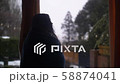 Woman Near window while snowing 58874041