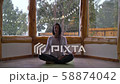 Woman Practicing Yoga Indoors In Winter 58874042