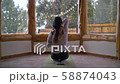 Woman Practicing Yoga Indoors In Winter 58874043