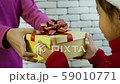 Asian little girl receiving a gift box 59010771