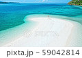 Happy woman walking on a perfect beach 59042814