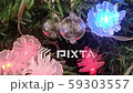 Stylish glass ball earrings hanging on Christmas tree. 59303557