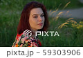 Close-up portrait of young attractive red-haired woman in park. Static shot 59303906