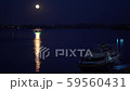 The ship floats on the river at night. The moon is shining. On the water the lunar path. 59560431