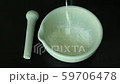 white powder pour into mortar and pestle on black color background for food,spa,herbal and pharmaceutical preparation. 59706478