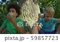 Multiracial friends talking through cans sitting 59857723