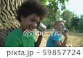 Happy multiethnic friends talking through cans 59857724