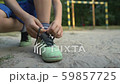 Boy footballer tying shoelaces, special orthopedic 59857725
