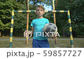 Self-confident boy footballer with ball looking at 59857727