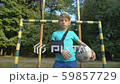 Upset boy wearing shoulder immobilizing sling for 59857729