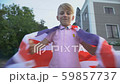 Young boy waving British flag, celebrating 59857737