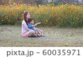 Happy family mother and son joyful in flowers field in summer at sunset time. 60035971
