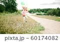 little girl with balloons in the park 60174082