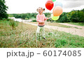 little girl with balloons in the park 60174085