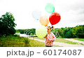 little girl with balloons in the park 60174087