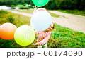 little girl with balloons in the park 60174090