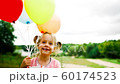 little girl with balloons in the park 60174523