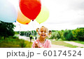 little girl with balloons in the park 60174524