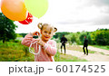 little girl with balloons in the park 60174525