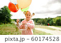 little girl with balloons in the park 60174528