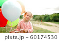 little girl with balloons in the park 60174530
