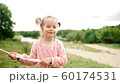 little girl with balloons in the park 60174531