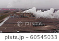 Wood processing plant pollutes the air with smoke coming from the pipe. Aerial view. 60545033