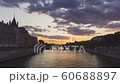 Sunset over Seine River and Conciergerie - Paris. Timelapse with boat traffic during Golden and Blue hours with illuminated bridges and monuments. 60688897