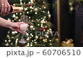 Celebration festive champagne pouring into a glass with gas and bubbles on the background of a Christmas tree in bokeh 60706510