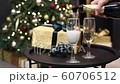 Celebration festive champagne pouring into a glass with gas and bubbles on the background of a Christmas tree in bokeh 60706512