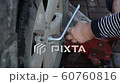 The man driver tighten the bolts to change the wheel of a car 60760816