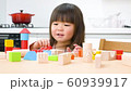 A girl playing with building blocks 60939917