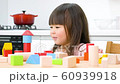 A girl playing with building blocks 60939918