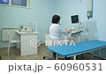 Woman doctor working at ultrasound diagnostic machine 60960531