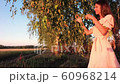 Young woman on wheat field at sunset 60968214