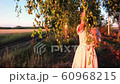 Young woman on wheat field at sunset 60968215