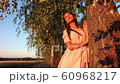 Young woman on wheat field at sunset 60968217