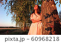 Young woman on wheat field at sunset 60968218