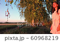 Young woman on wheat field at sunset 60968219