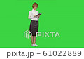 Pretty young woman using tablet on a Green Screen, Chroma Key 61022889