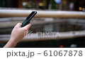 Cropped hand of woman used mobile phone blurred background 61067878