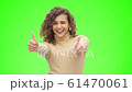 Afro-american girl gestures thumbs up with smiling facial expression. Close up. Copy space. 4K. 61470061