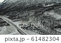 cinematic view of road near rocky snowy mountain landscape 61482304