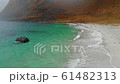 amazing cinematic view of a sandy sea shore with waves and mountains 61482313